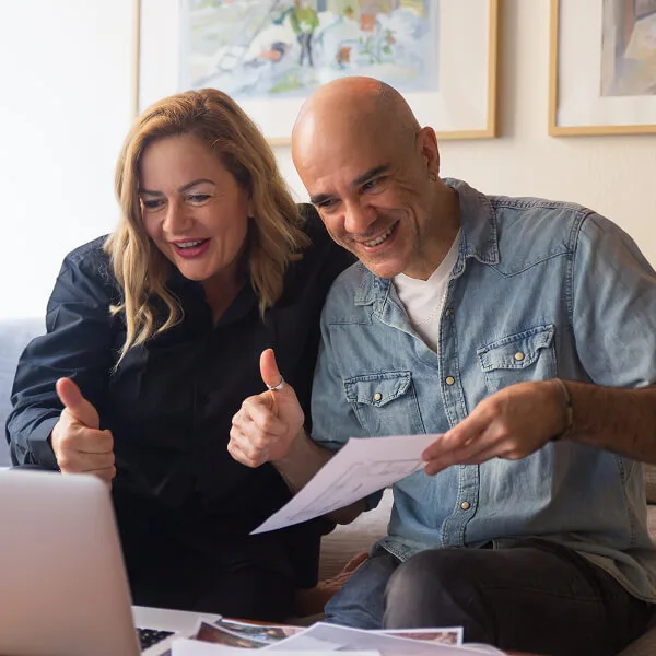 Couple heureux consultant des documents financiers après avoir obtenu un financement alternatif